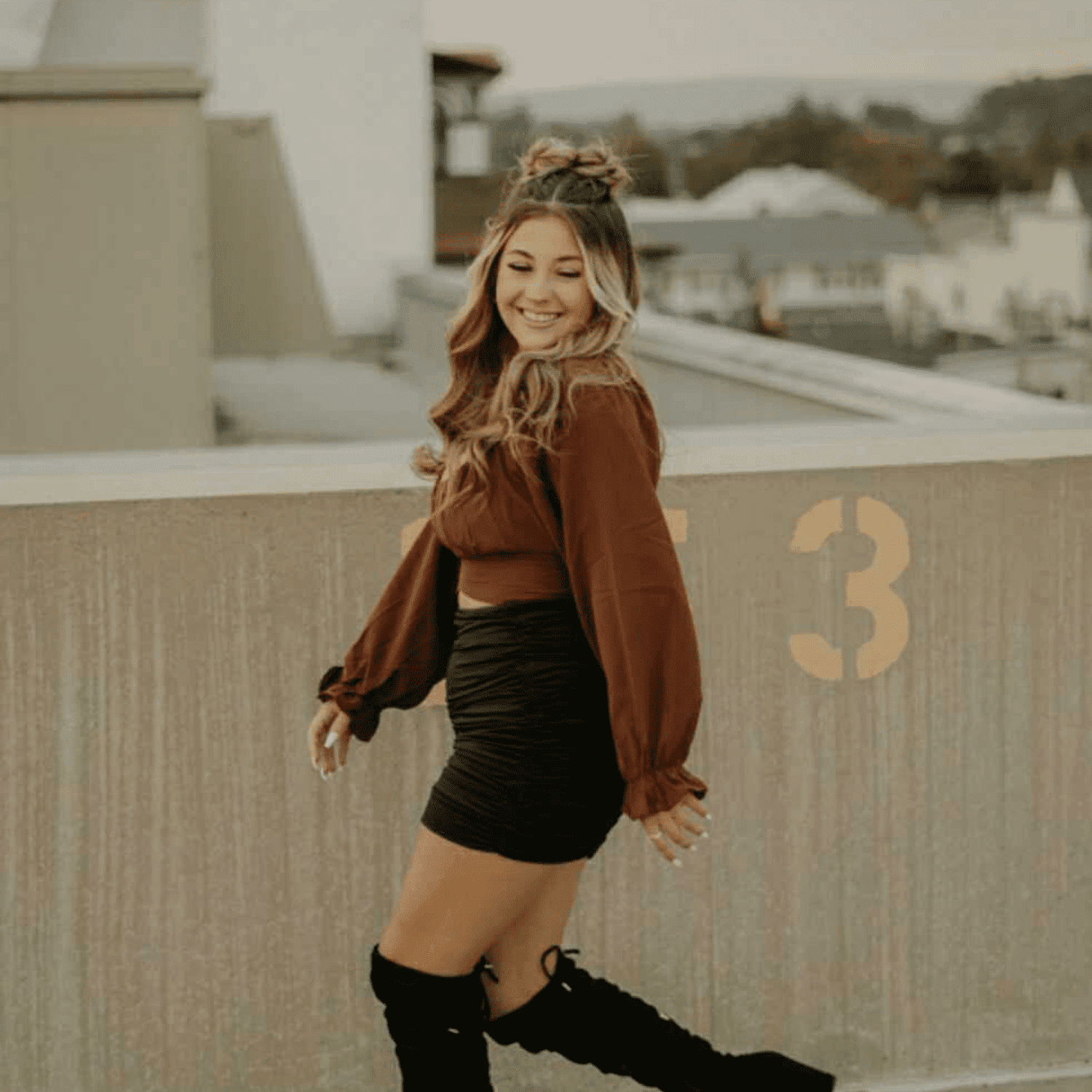 Portrait of Cameryn, a professional stylist at Meraki Salon & Spa, showcasing their expertise and style.