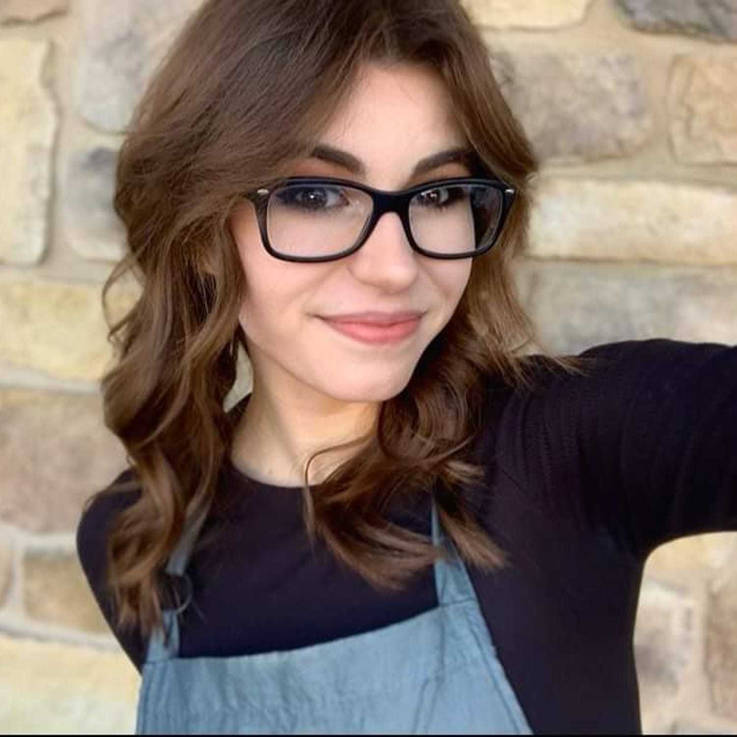 Portrait of Sam, a professional stylist at Meraki Salon & Spa, showcasing their expertise and style.