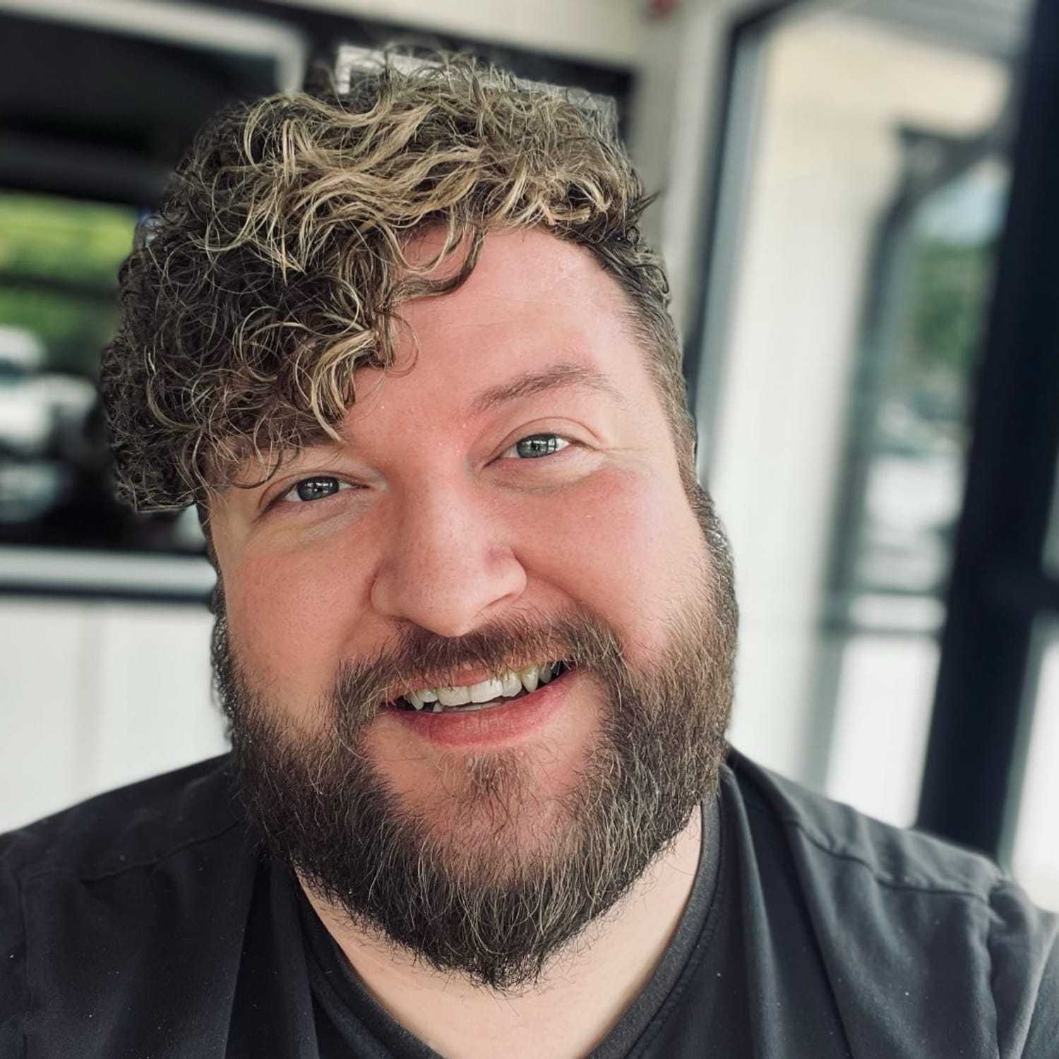 Portrait of Justin, a professional stylist at Meraki Salon & Spa, showcasing their expertise and style.